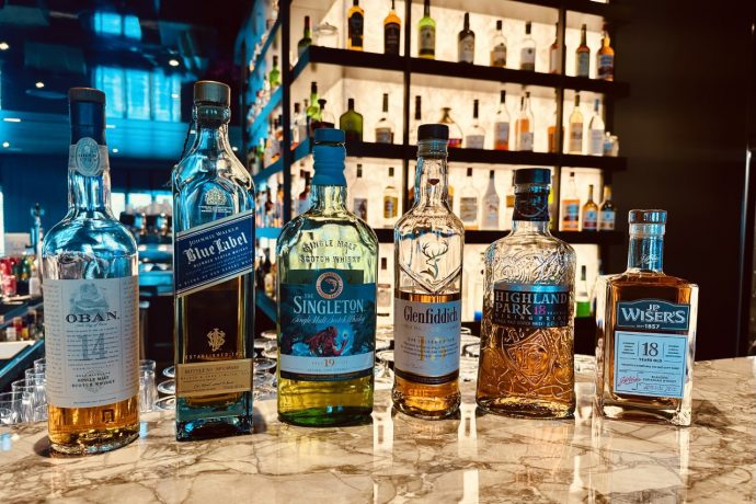 scenic eclipse whiskey bar a group of bottles of alcohol on a counter