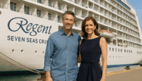 a man and woman standing in front of a large cruise ship