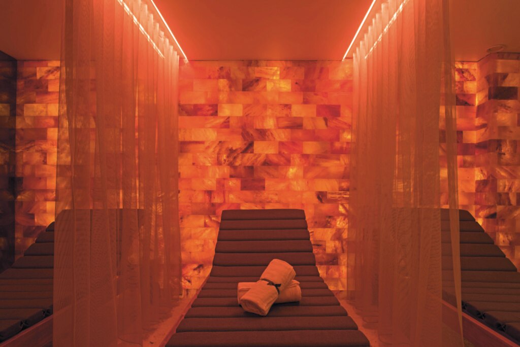 a massage chair in a room with a red light