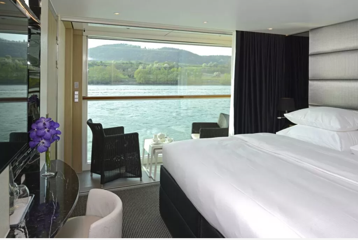a room with a large window overlooking a lake
