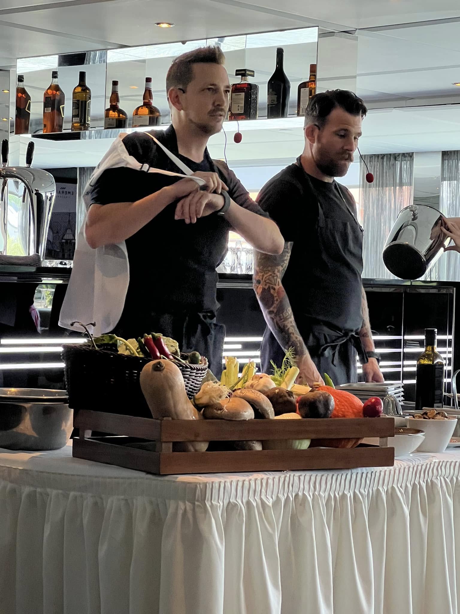 a group of men standing in a kitchen