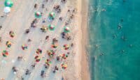 a group of people on a beach with umbrellas