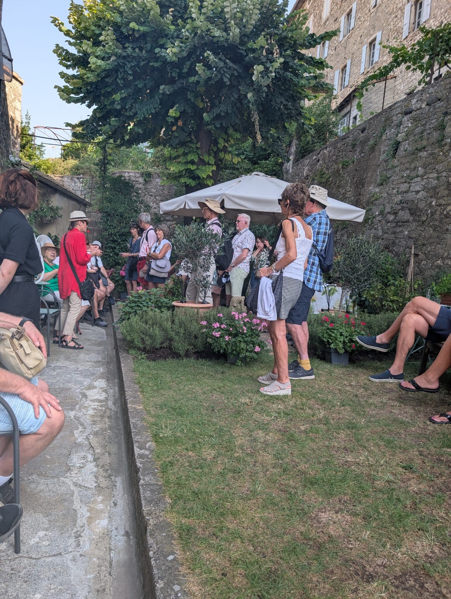 a group of people standing in a garden