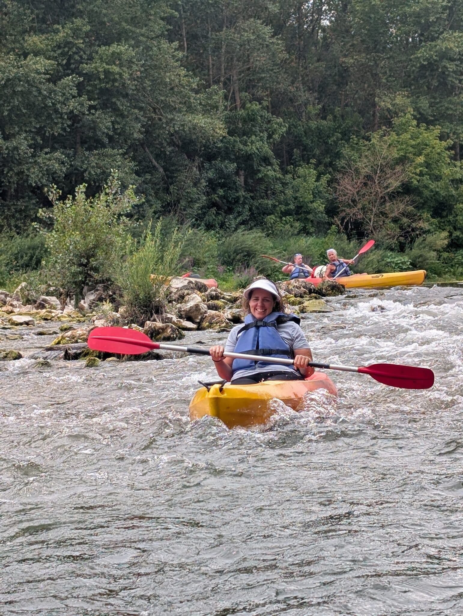 a woman in a kayak on a river