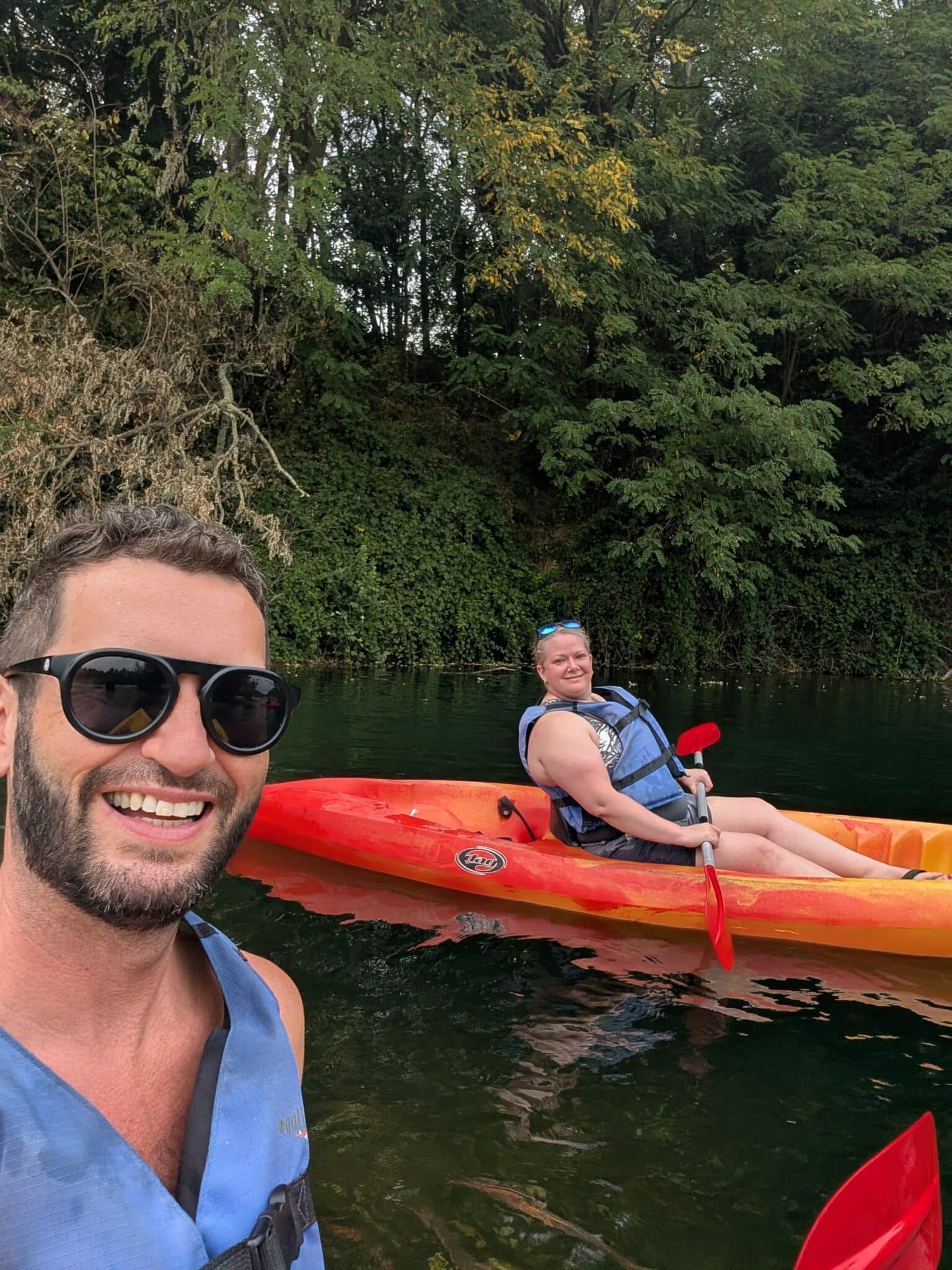 a man taking a selfie with a woman in a kayak