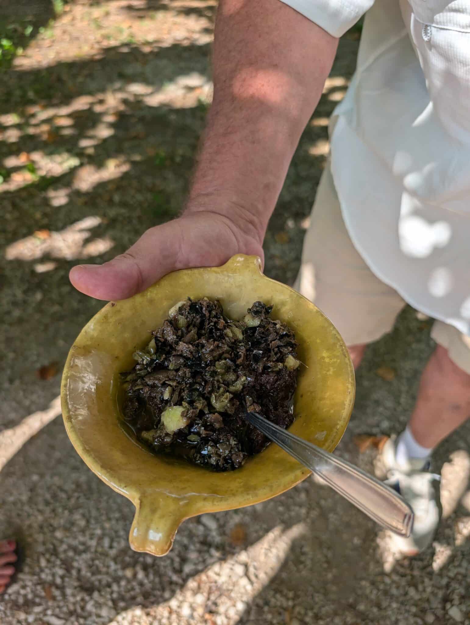 a person holding a bowl of food