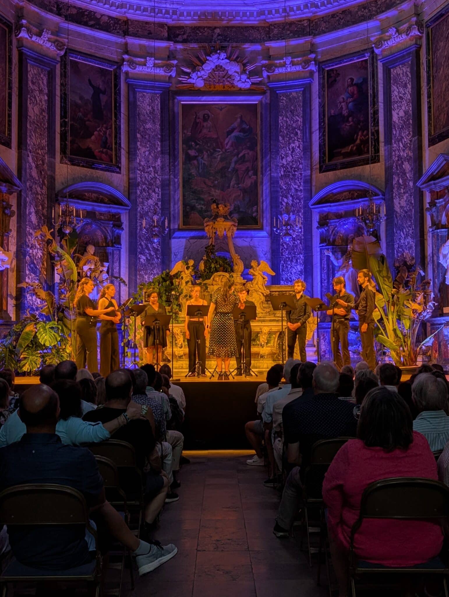a group of people on a stage with a crowd watching
