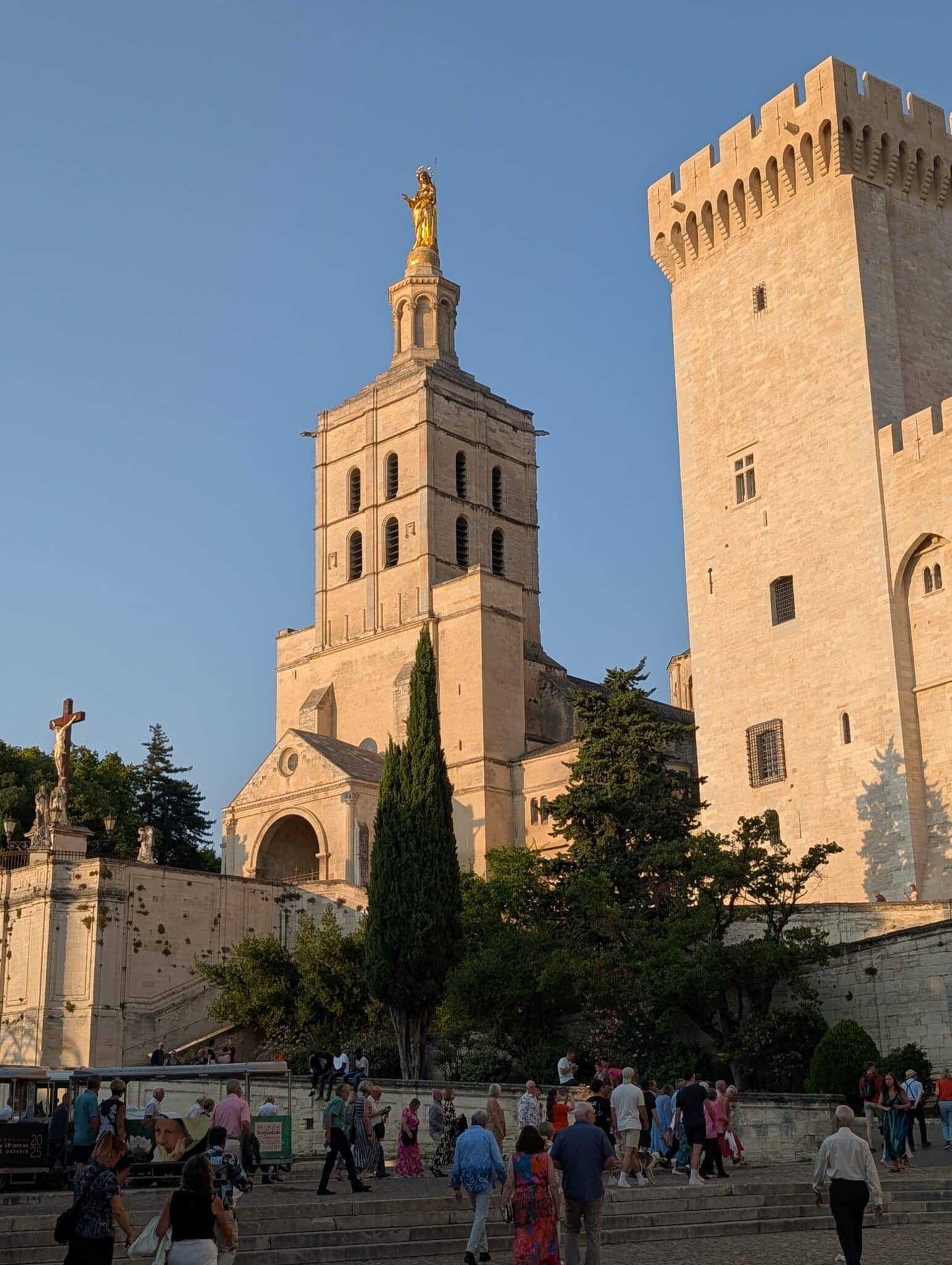 a group of people standing outside of a castle