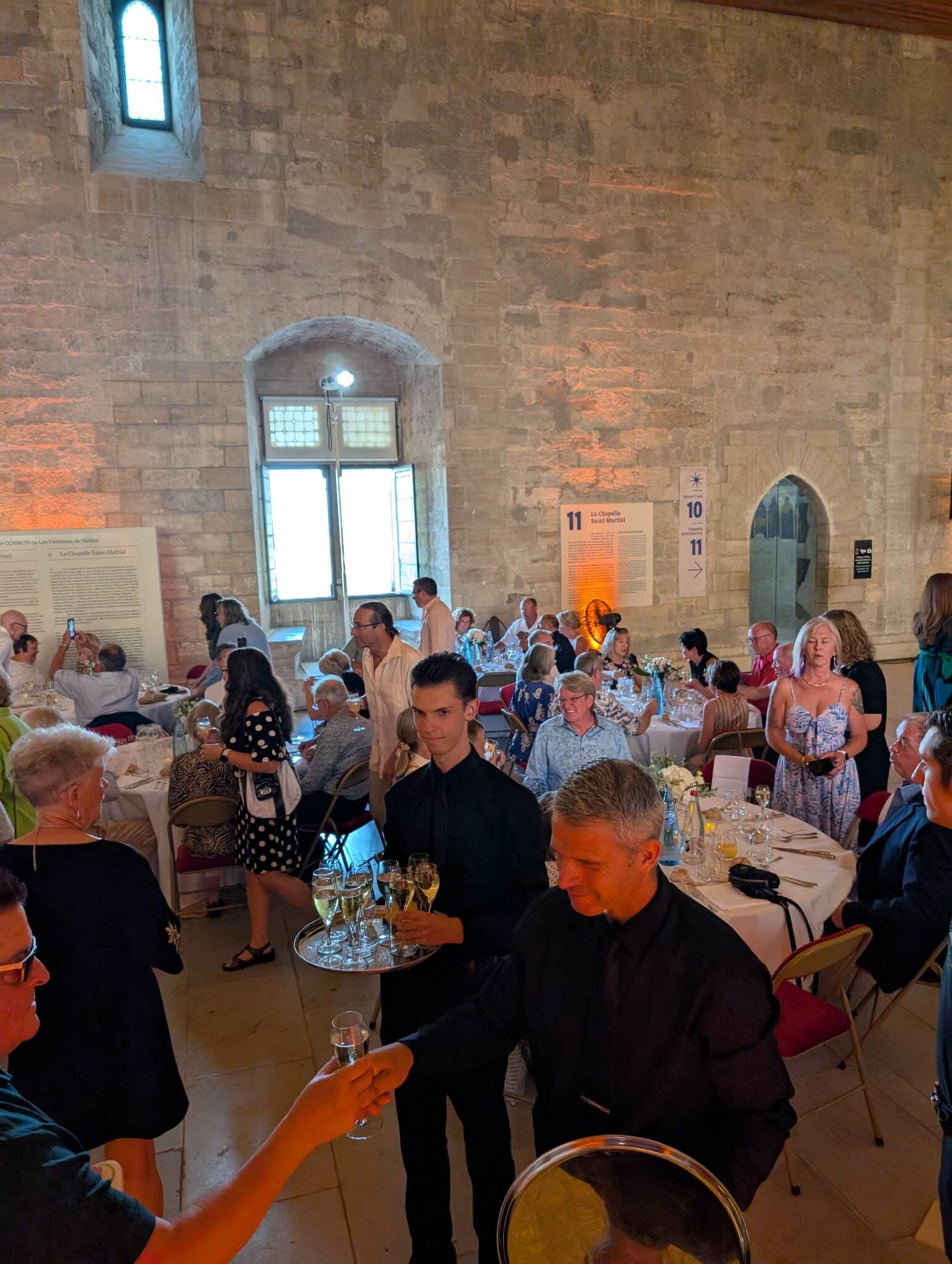 a group of people in a room with tables and chairs