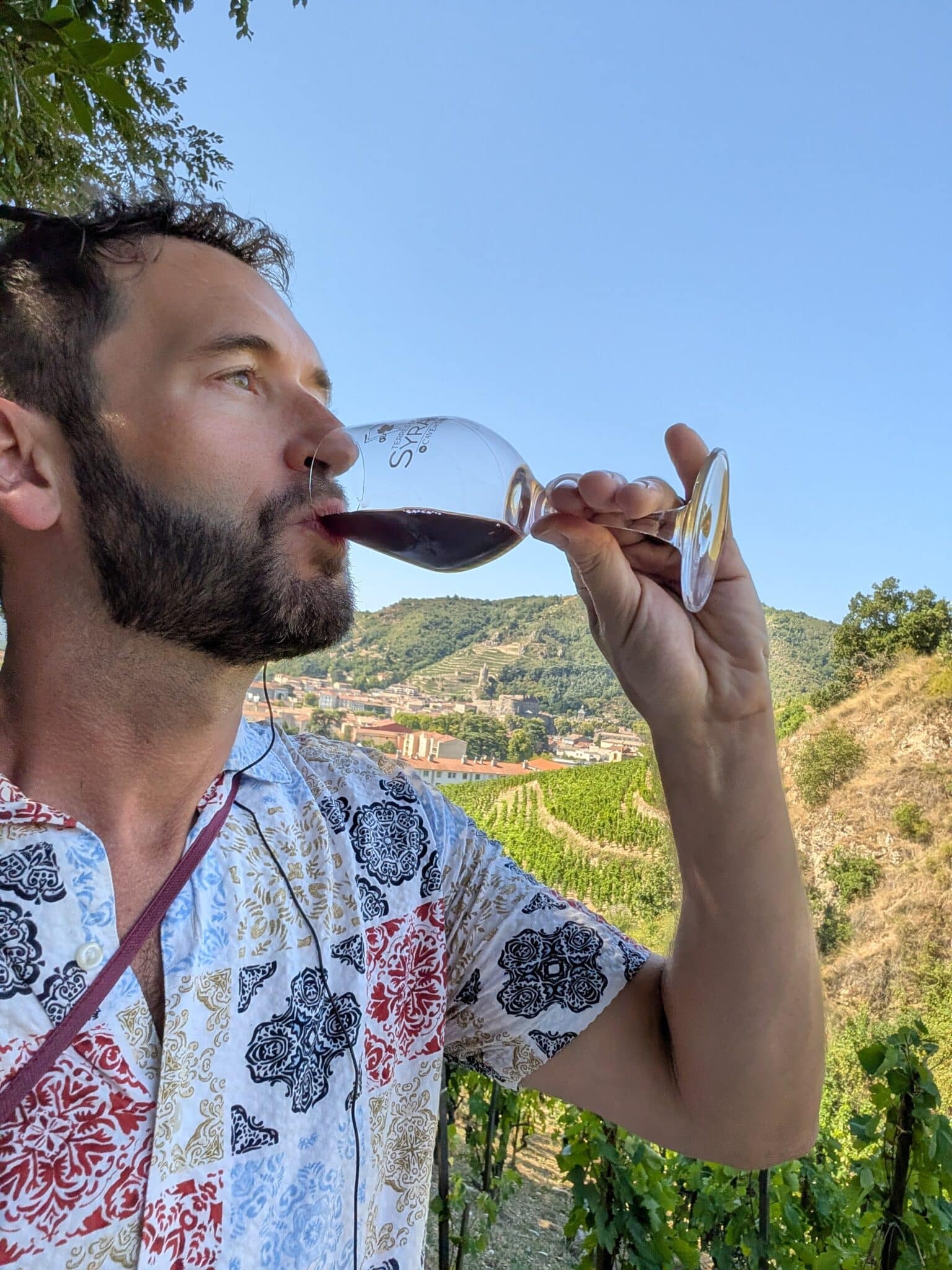 a man drinking from a wine glass
