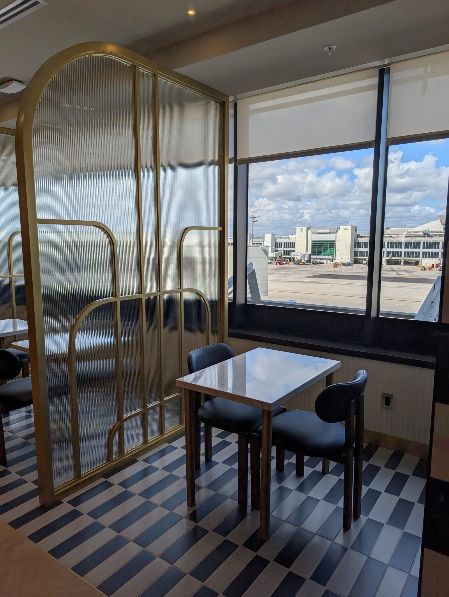 a table and chairs in a room with a glass partition