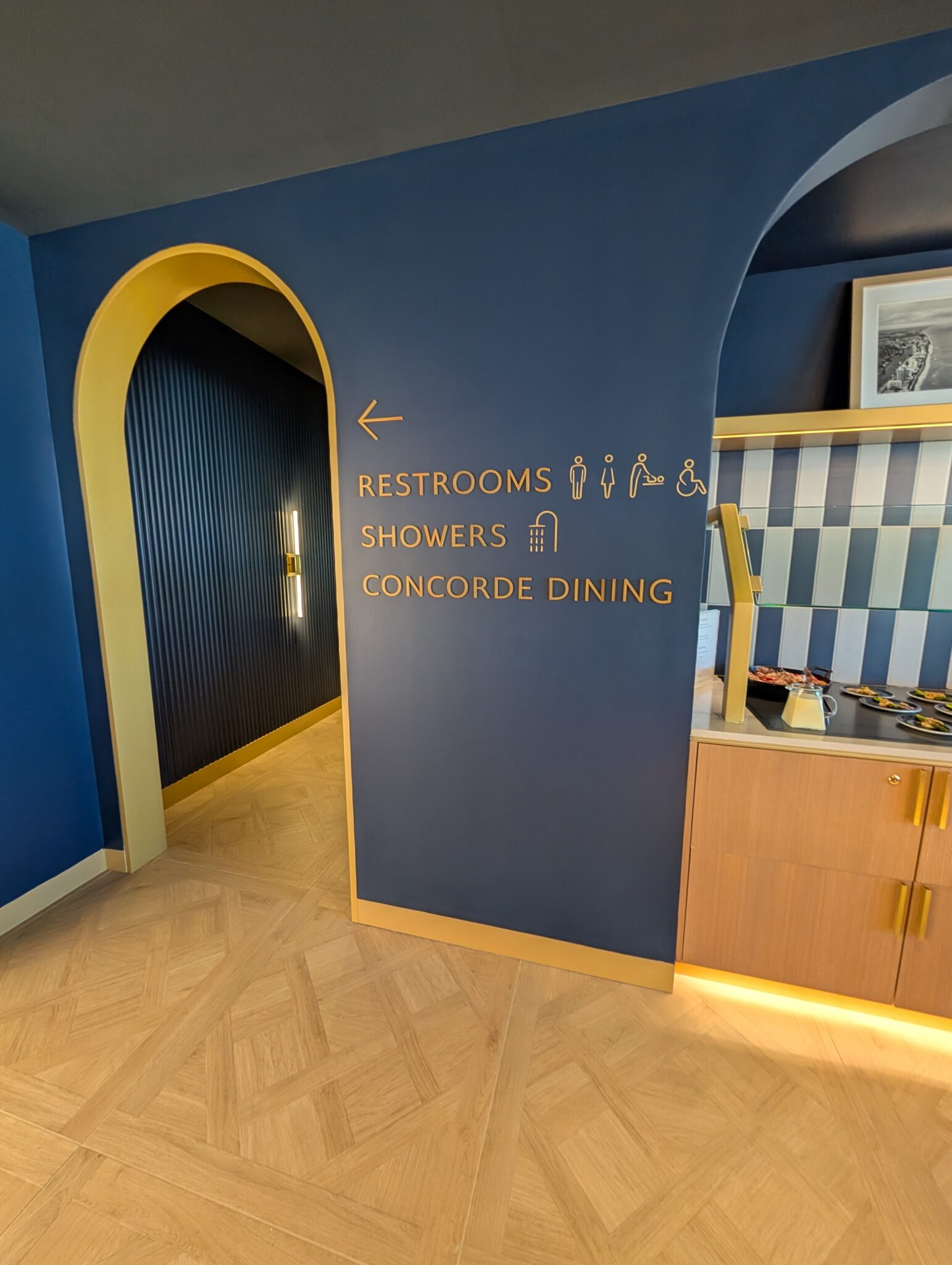 a blue and white hallway with a sign on the wall