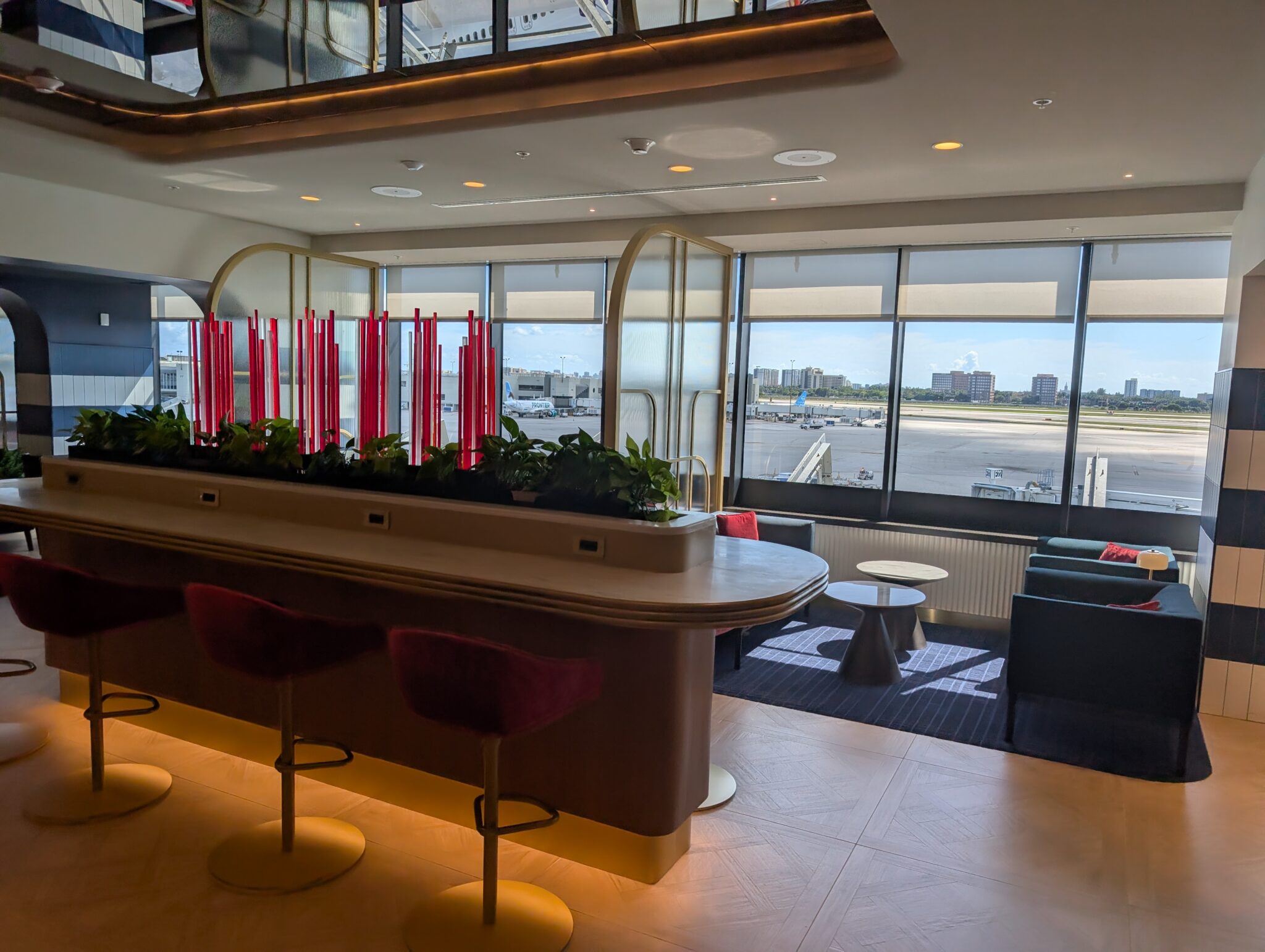 a bar with chairs and a plant in it