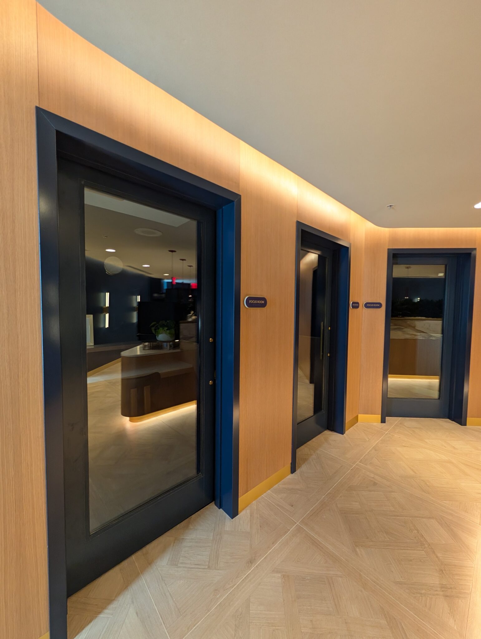 a hallway with doors and a mirror