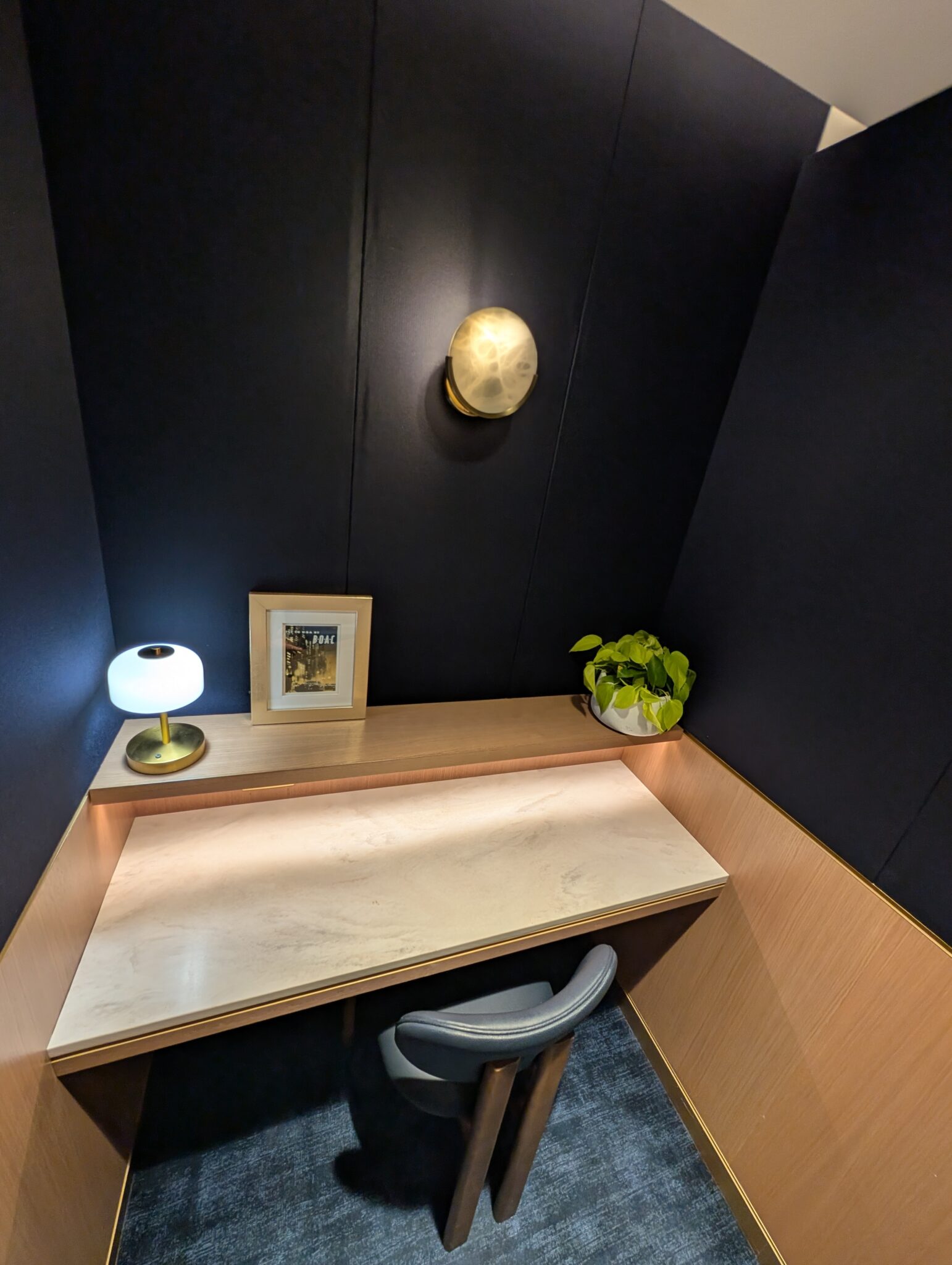 a desk with a lamp and picture on it