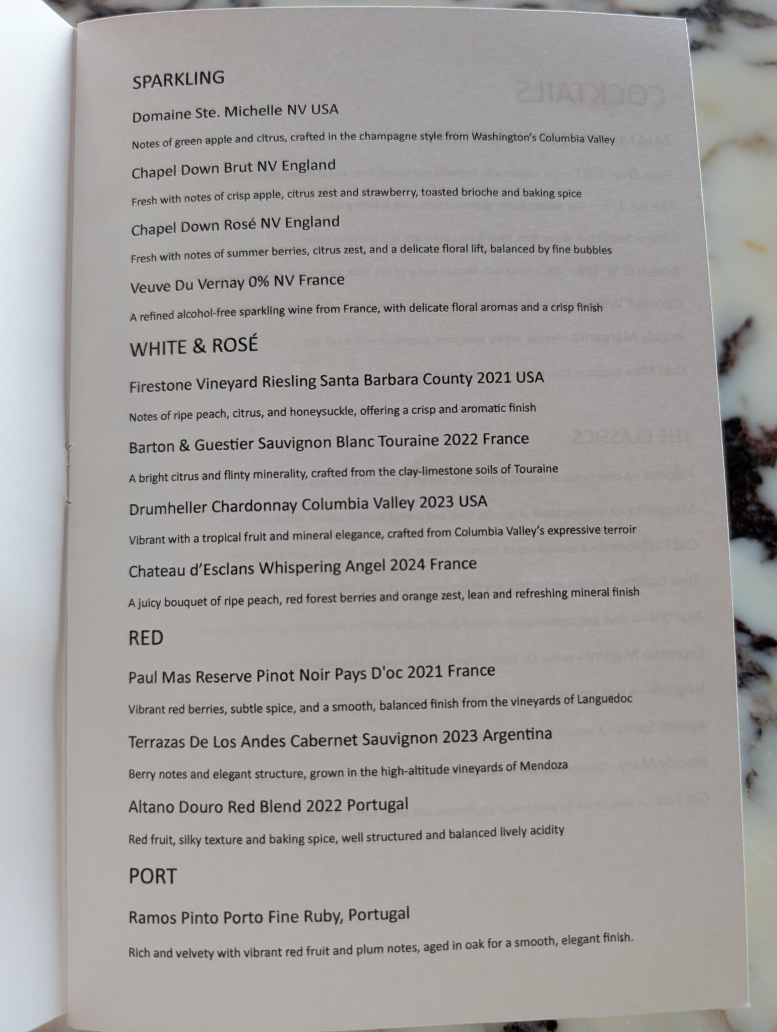 a menu on a marble surface