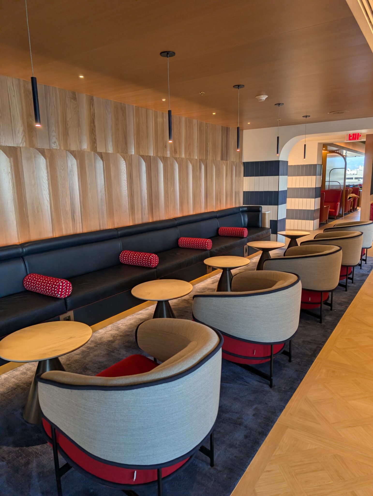 a room with a long couch and tables