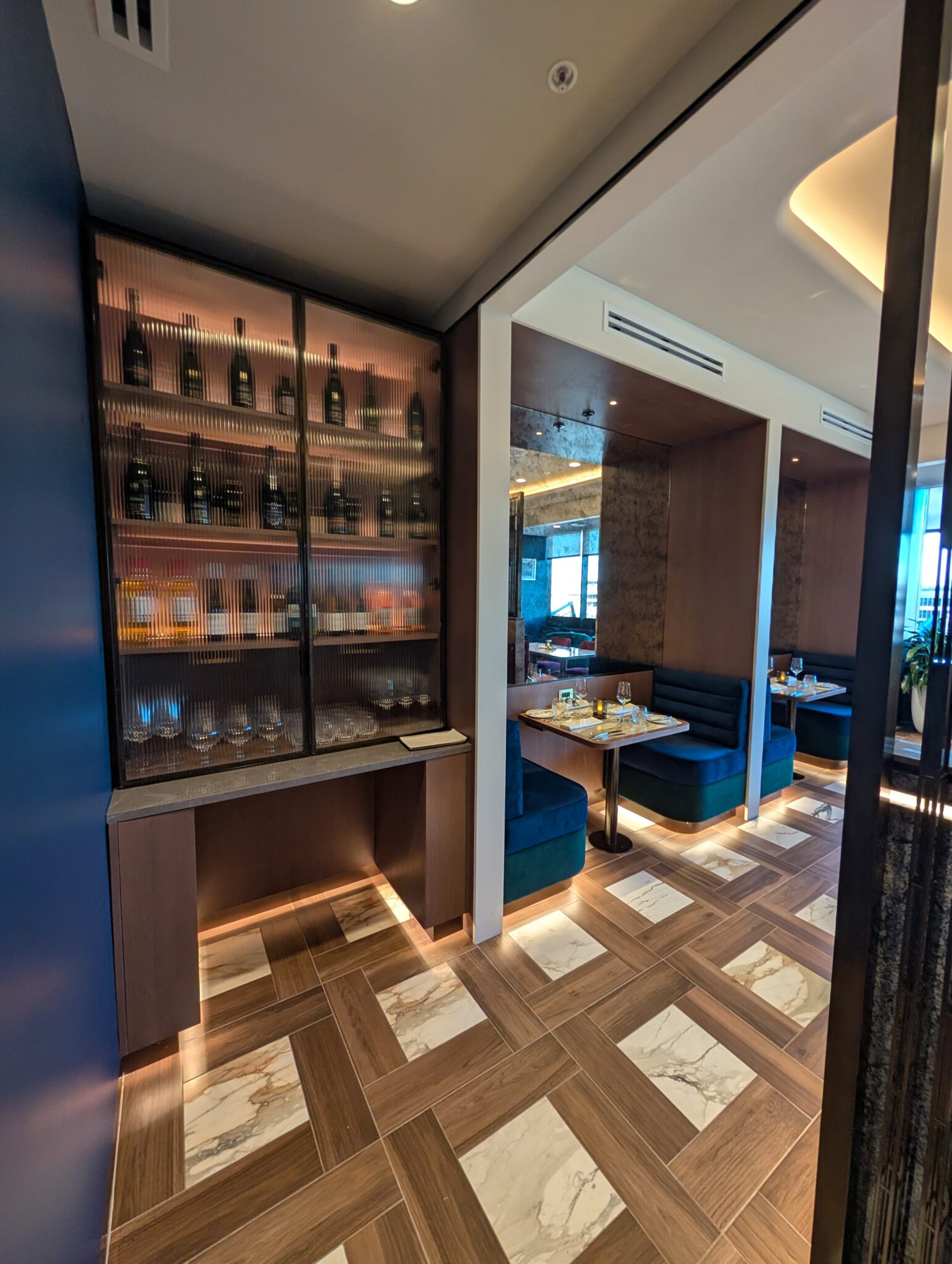 a room with a glass cabinet and tables
