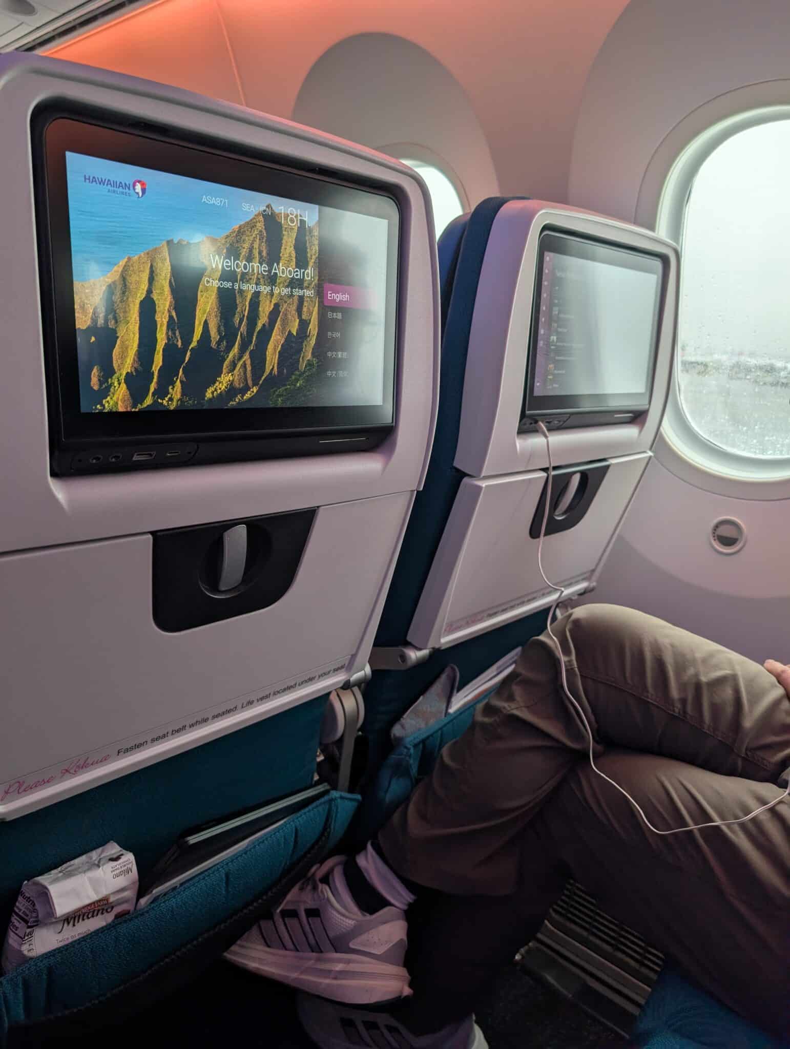 a man sitting in an airplane with headphones on