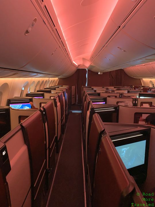 an airplane with rows of seats and a television
