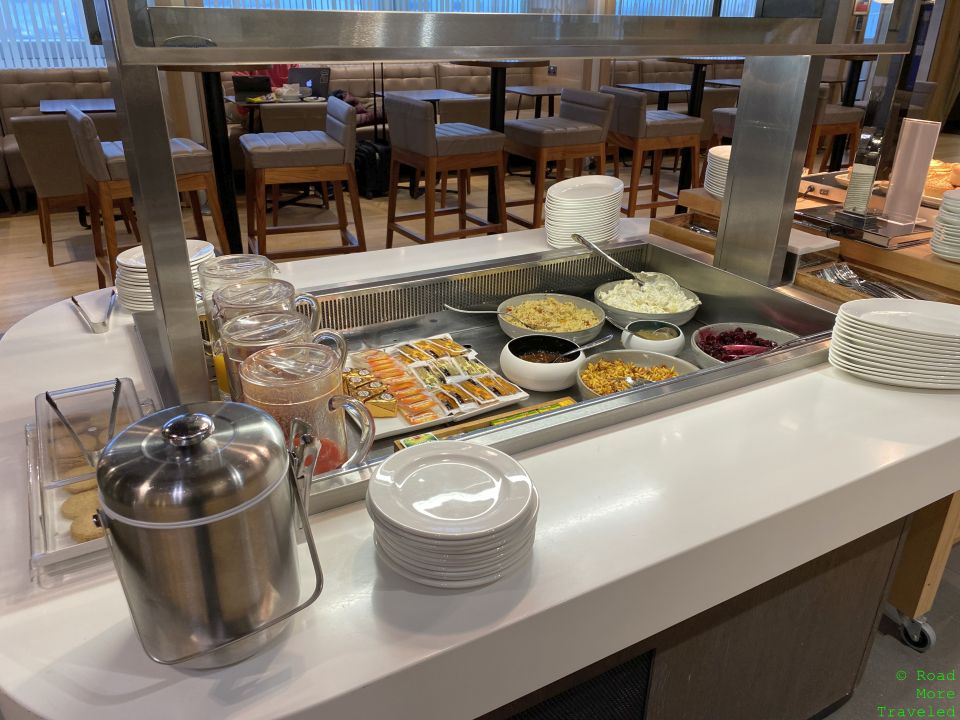 a buffet line with plates and food on it