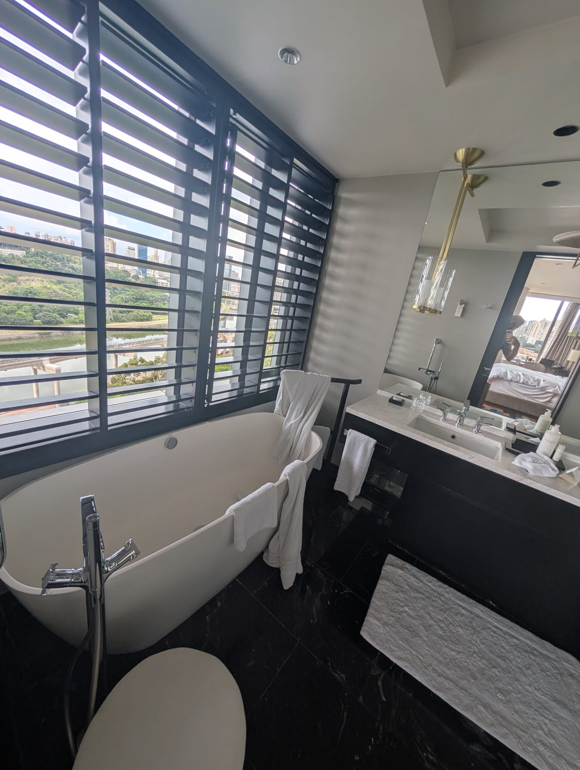 a bathroom with a tub and sink and a mirror