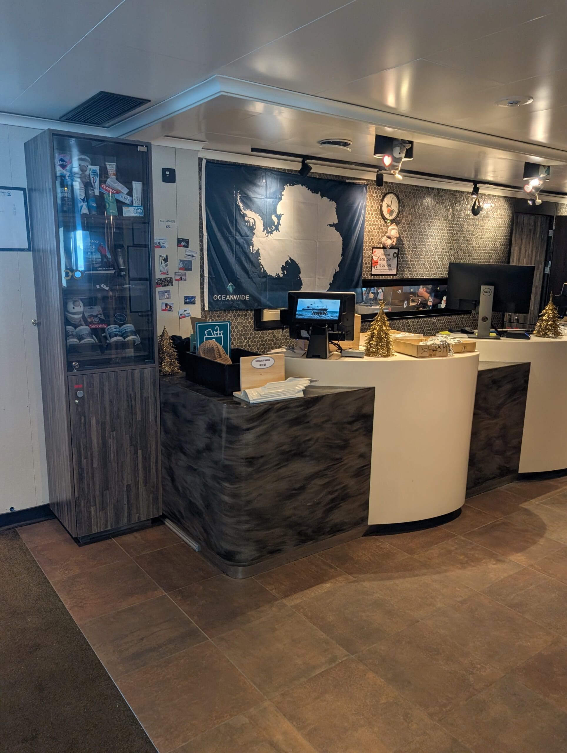 a reception area with computers and a glass case