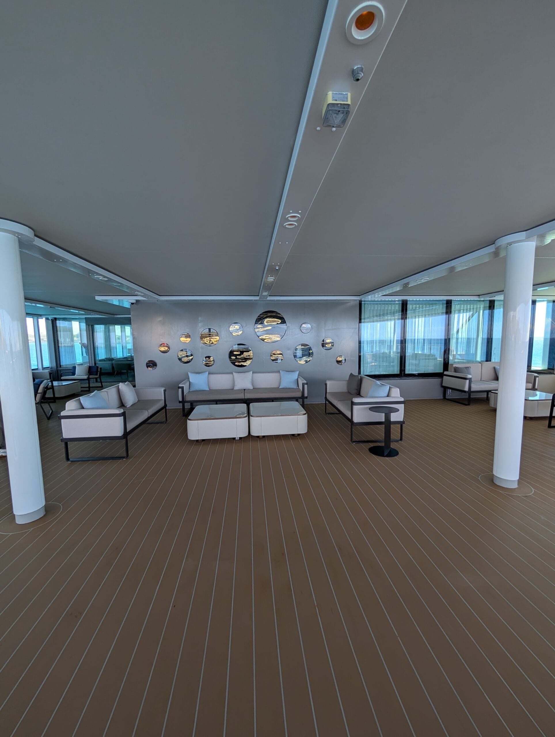 a room with white couches and white columns