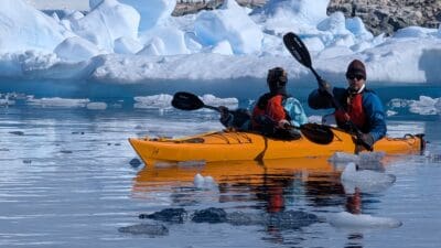 two people in a kayak on the water