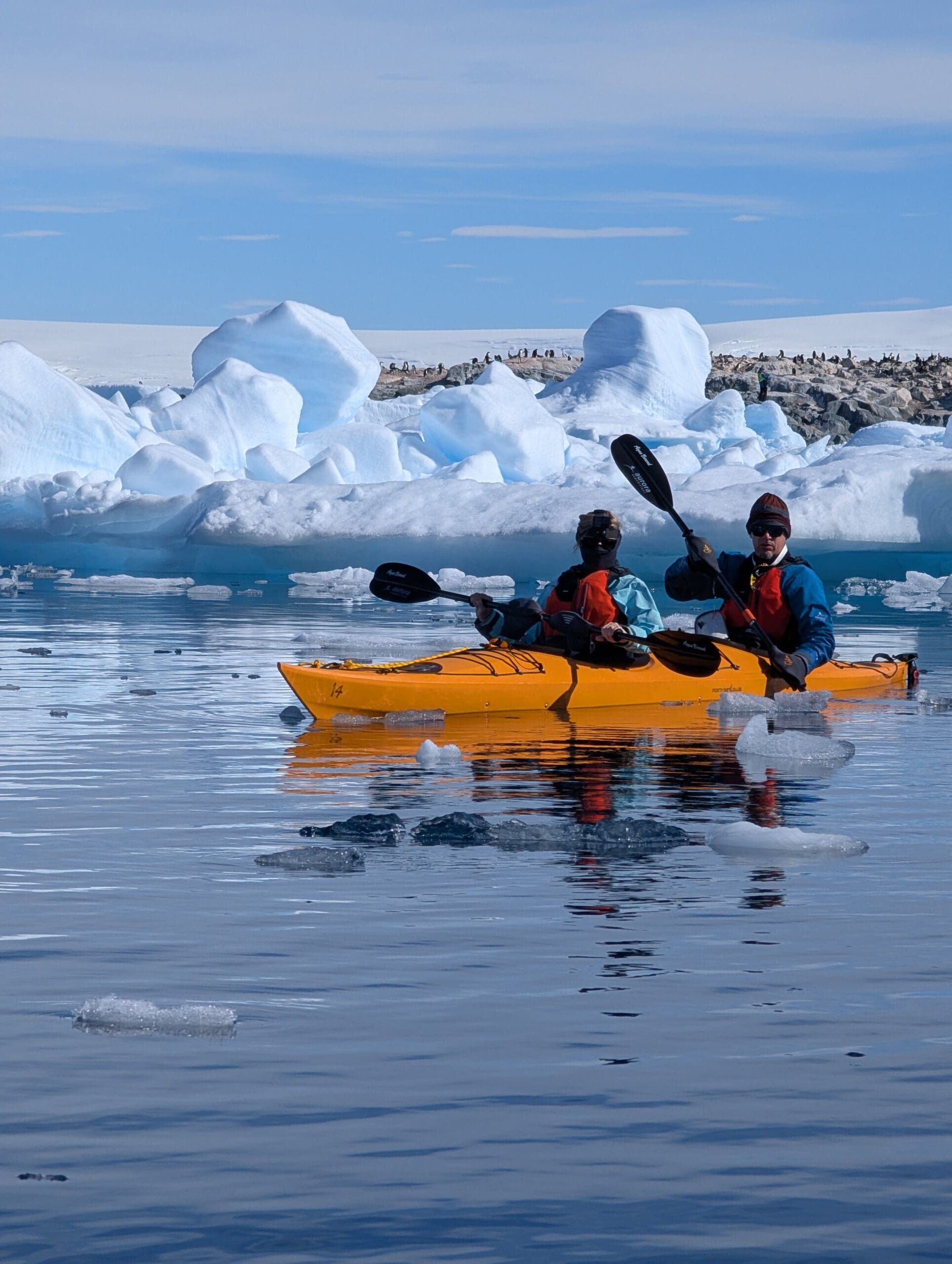 two people in a kayak on the water