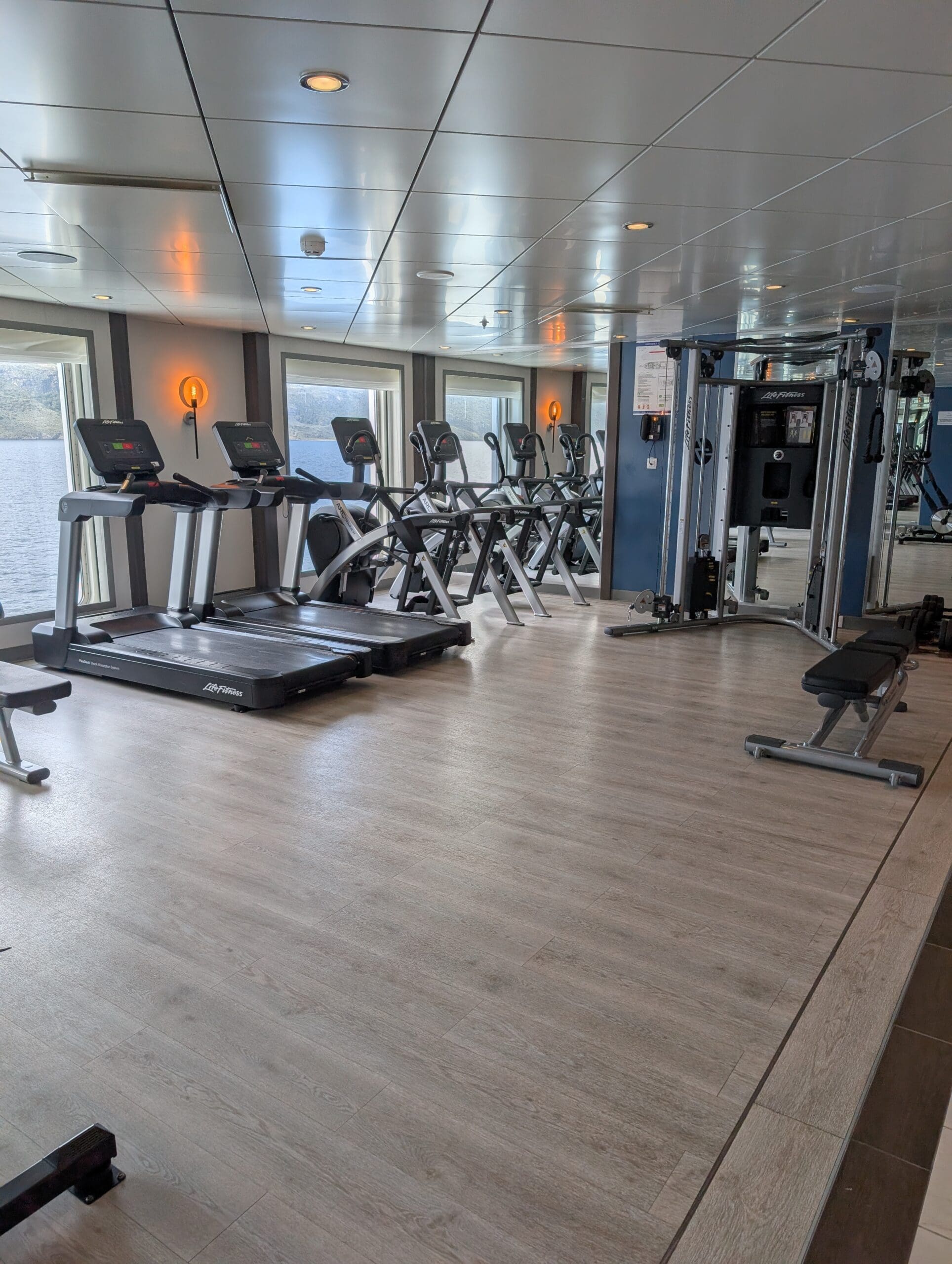 a gym with exercise equipment and windows