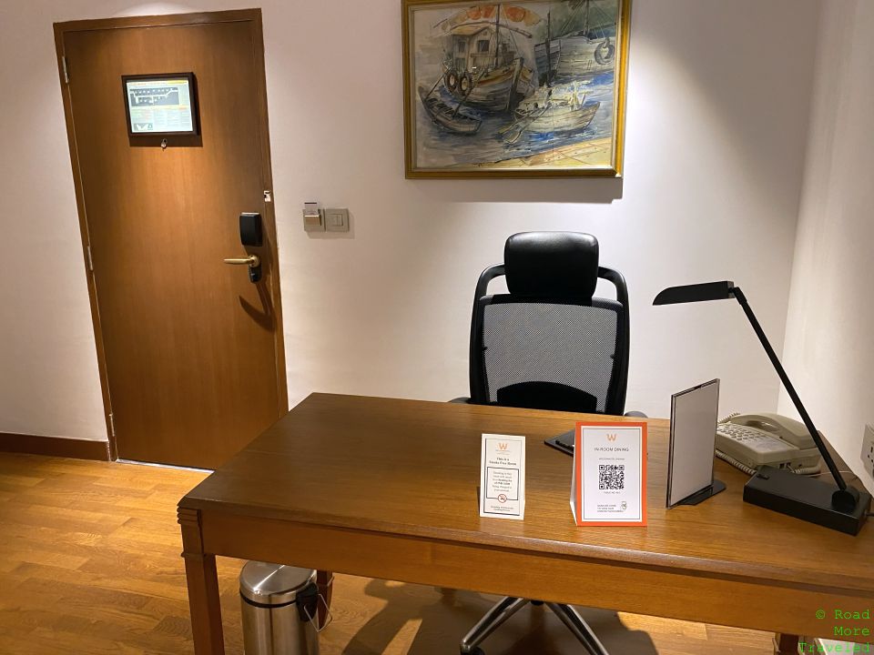 a desk with a chair and a desk lamp