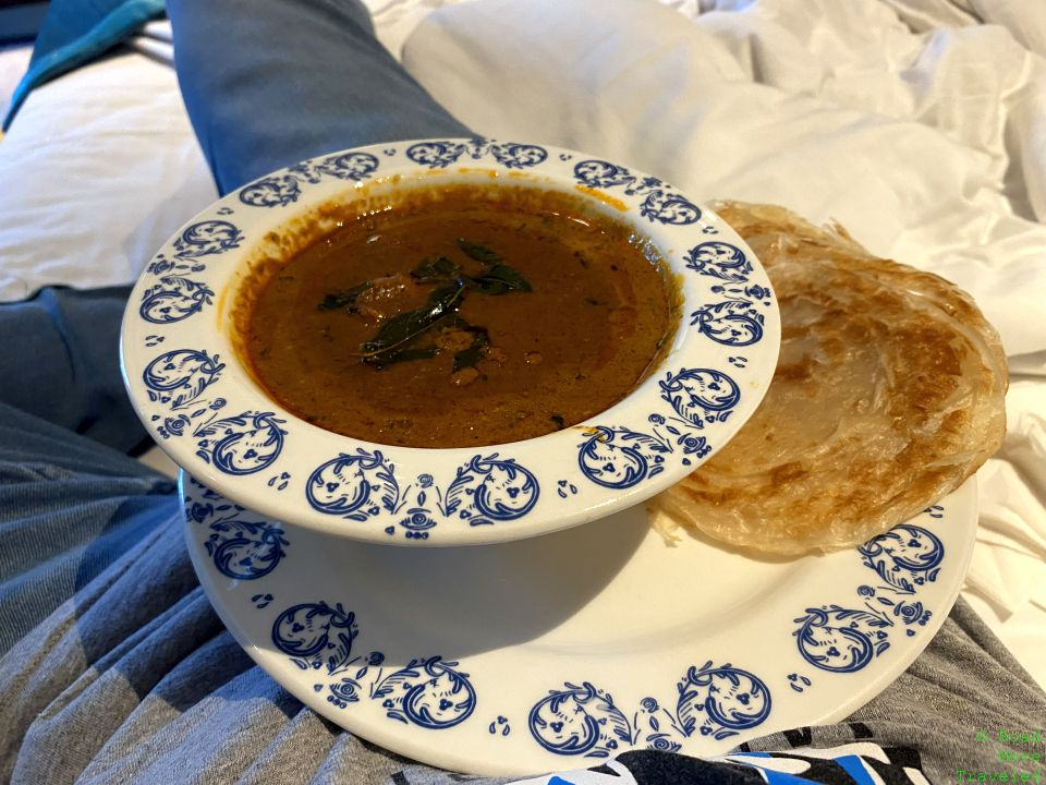 a bowl of soup and a bread on a plate