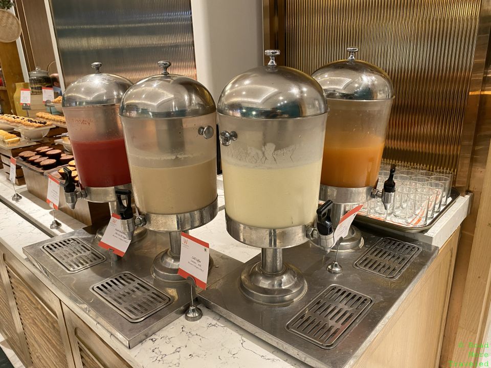a group of drinks dispensers on a counter