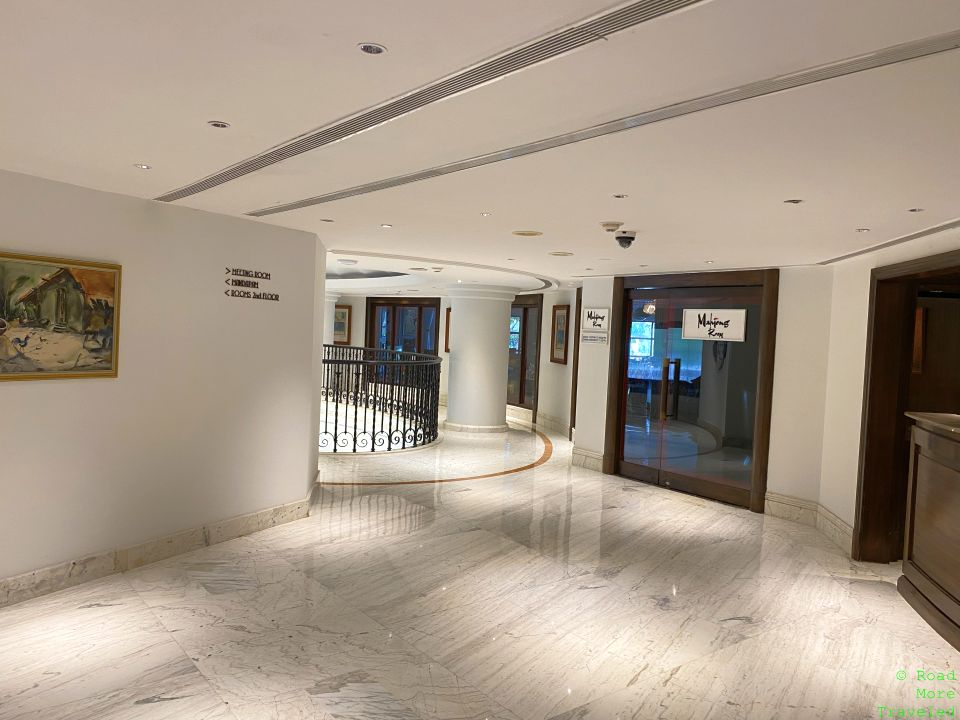 a hallway with a railing and a glass door