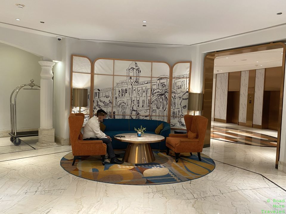 a man sitting in a chair in a lobby