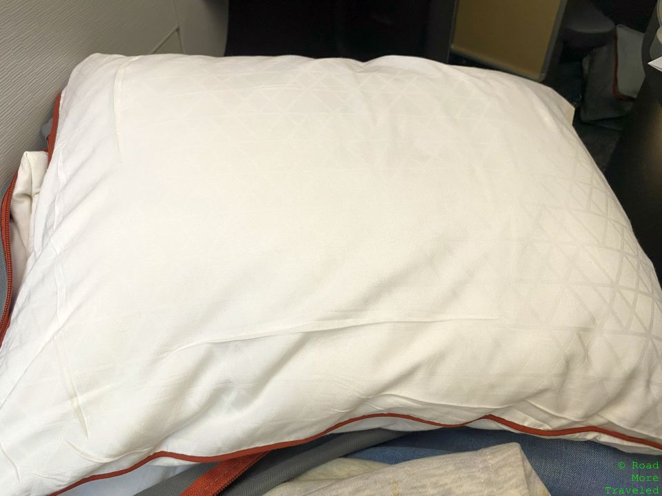 a white pillow on a bed