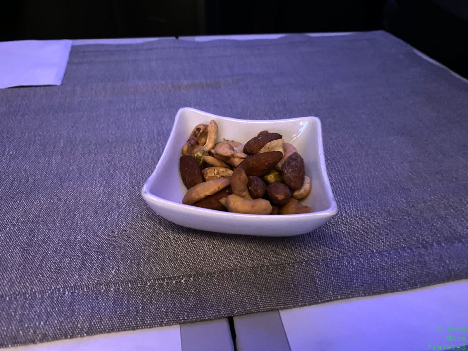 a bowl of nuts on a place mat