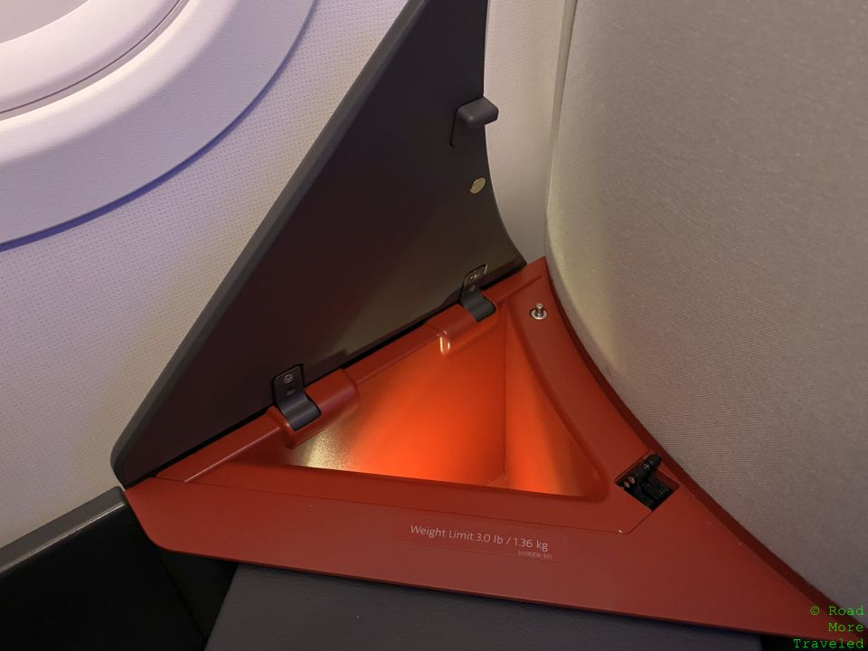 a corner of an airplane with a red light