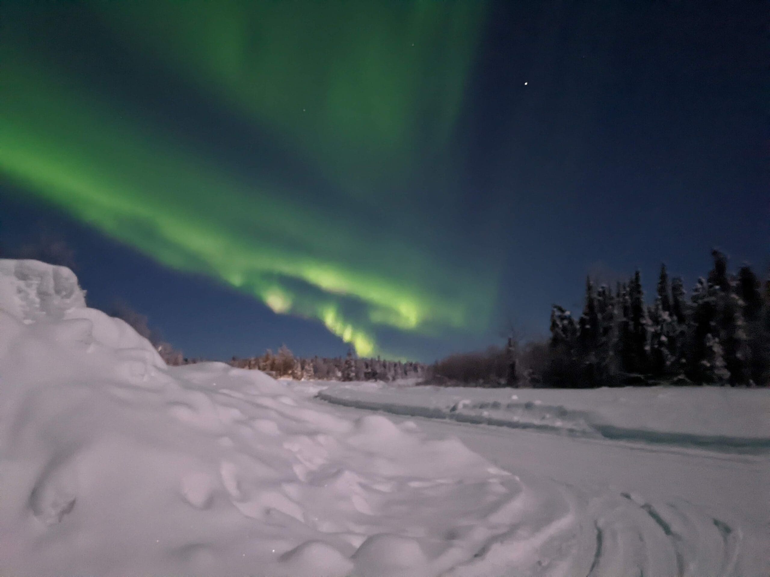 green lights in the sky over snow