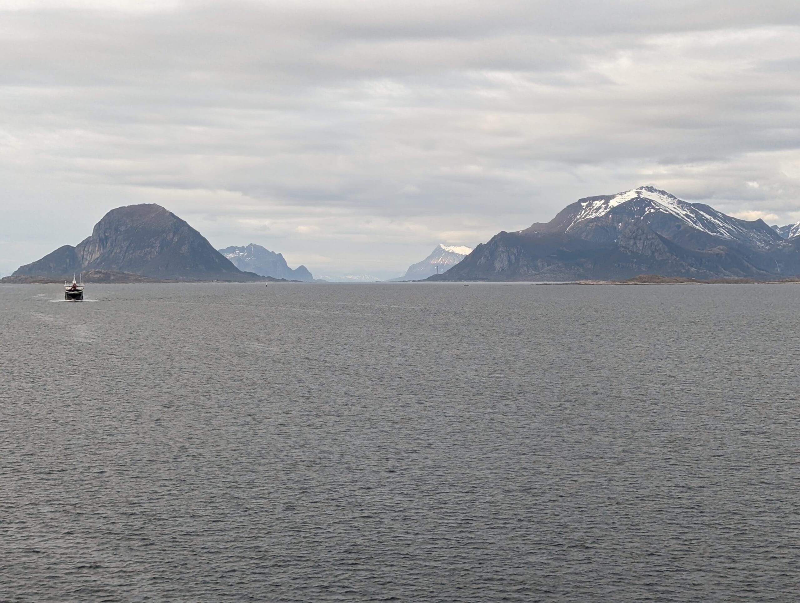 a body of water with mountains in the background