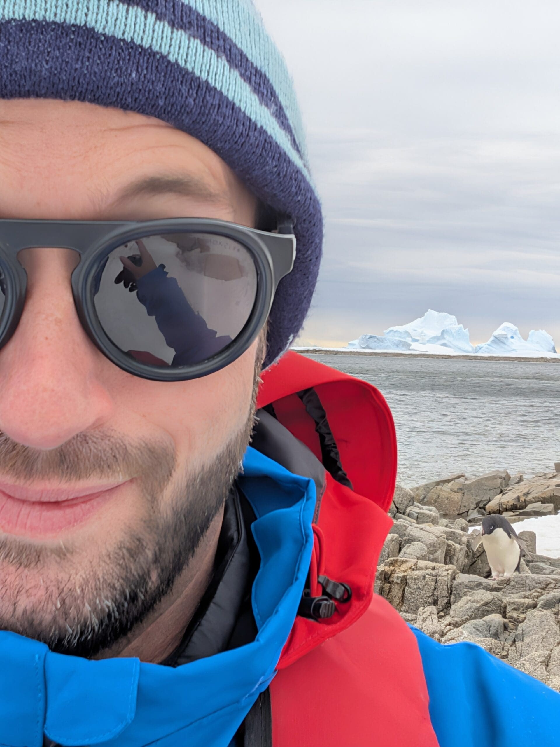 a man wearing sunglasses and a hat taking a selfie