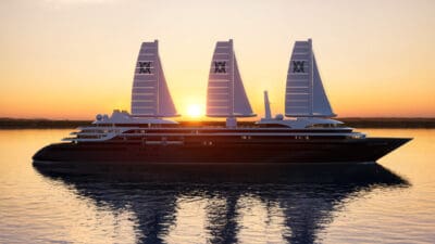 a large ship with sails on water