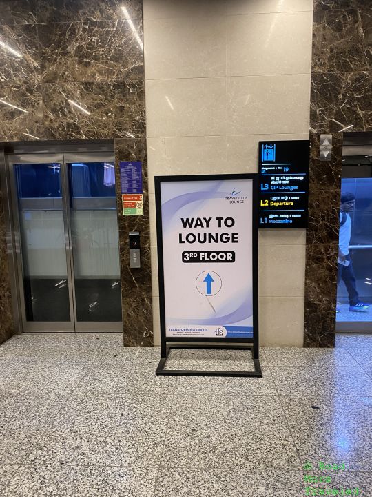 a sign in front of an elevator