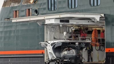 a helicopter being loaded into a ship