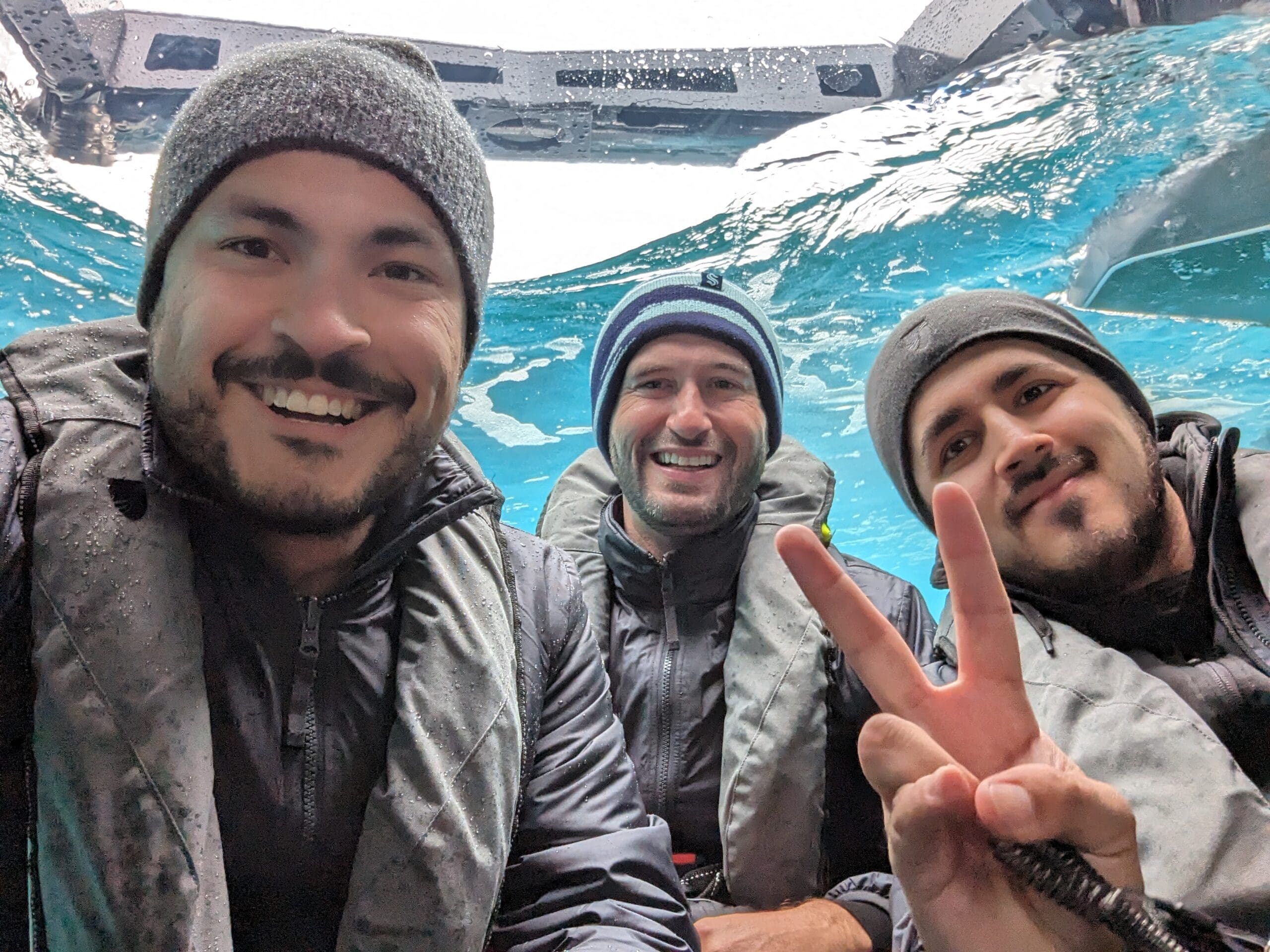 a group of men in winter clothes under water