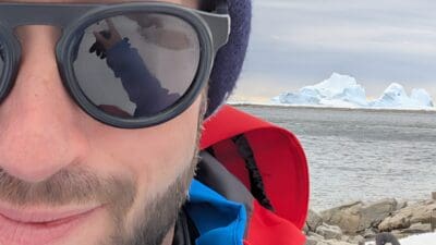 a man wearing sunglasses and a hat taking a selfie