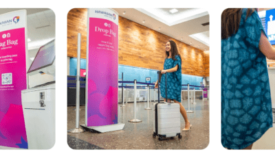 a woman in a blue dress pulling a luggage bag